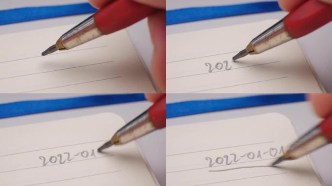 2022年日期手写用自动铅笔在笔记本日记页面角开始新年决议列表新的开始