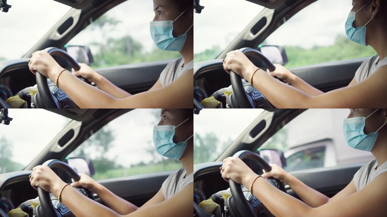 车内戴防护口罩的亚裔女子