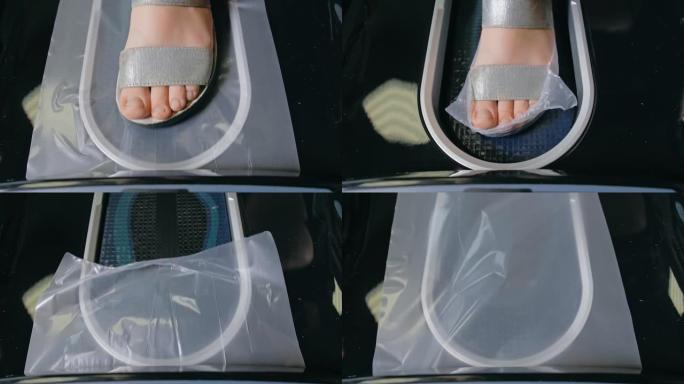 自动热收缩鞋套覆膜机。特写。机器自动将鞋套涂在病人的鞋子上。