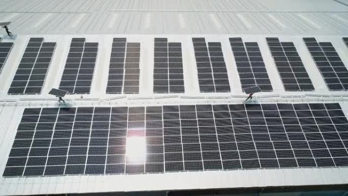 在屋顶上安装太阳能电池板的技术人员的Arial视图。