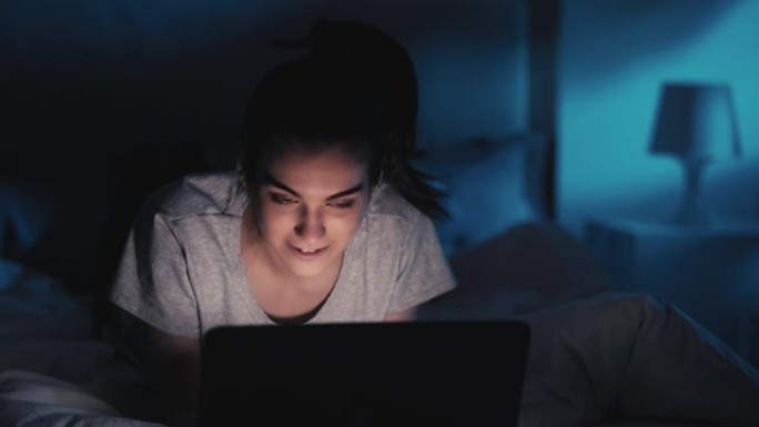 夜间聊天网瘾快乐女人笔记本电脑床