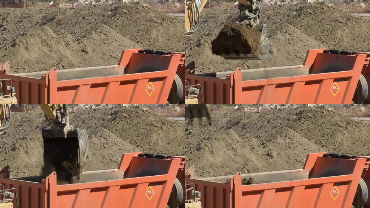 挖掘机将地面挖泥机放在卡车上