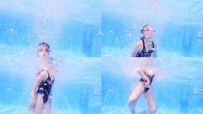 水下气泡从在酒店游泳池游泳的女孩慢慢上升到水面