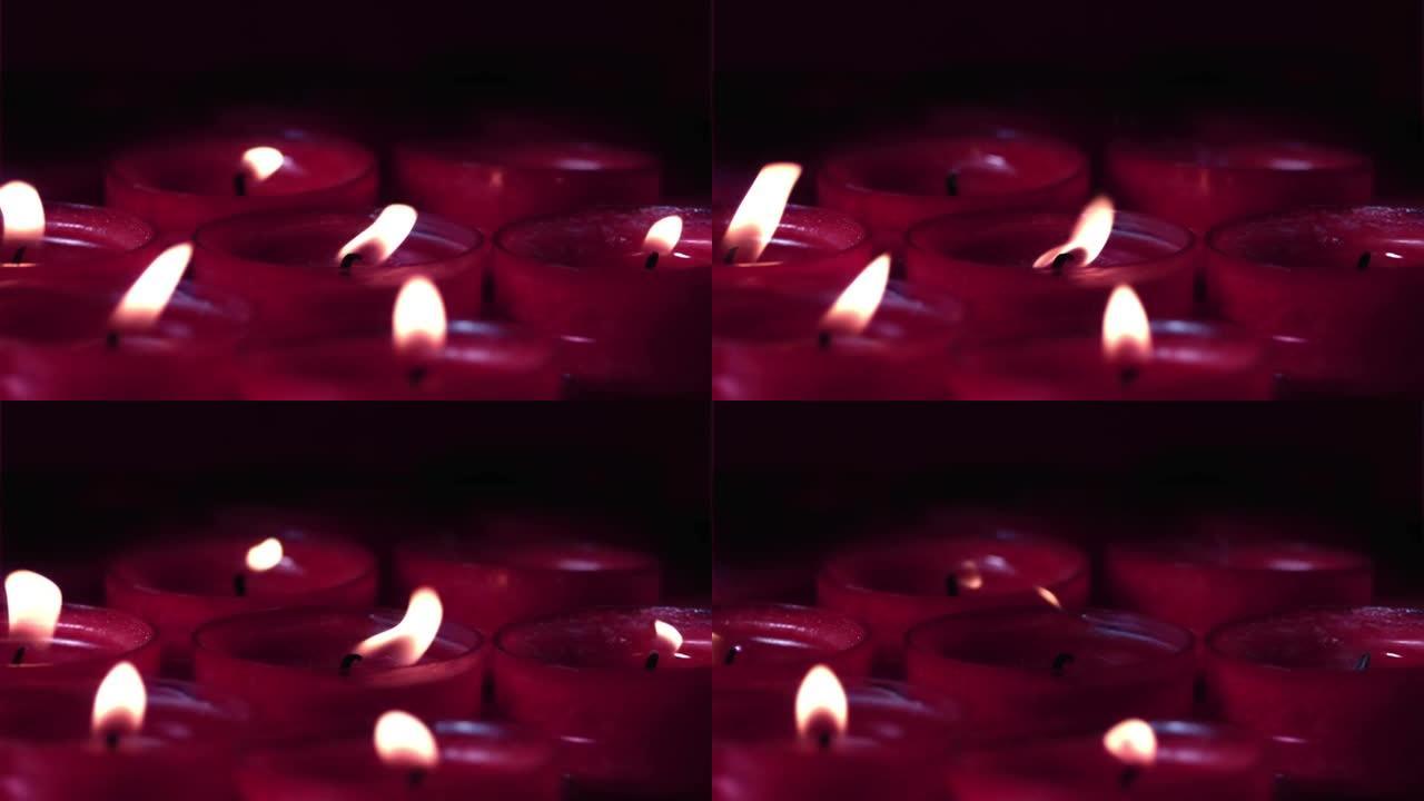 黑色背景下漂浮在燃烧的红色蜡烛上的红色粒子的数字组成