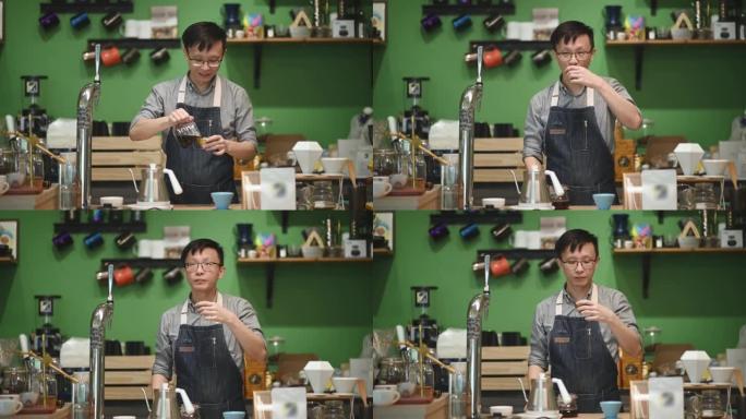 亚洲中国咖啡师咖啡馆老板在咖啡馆酒吧柜台享用研磨咖啡
