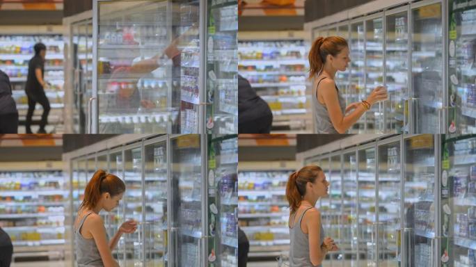 亚洲旅行期间，年轻女性旅行者购买酸奶并在超市散步