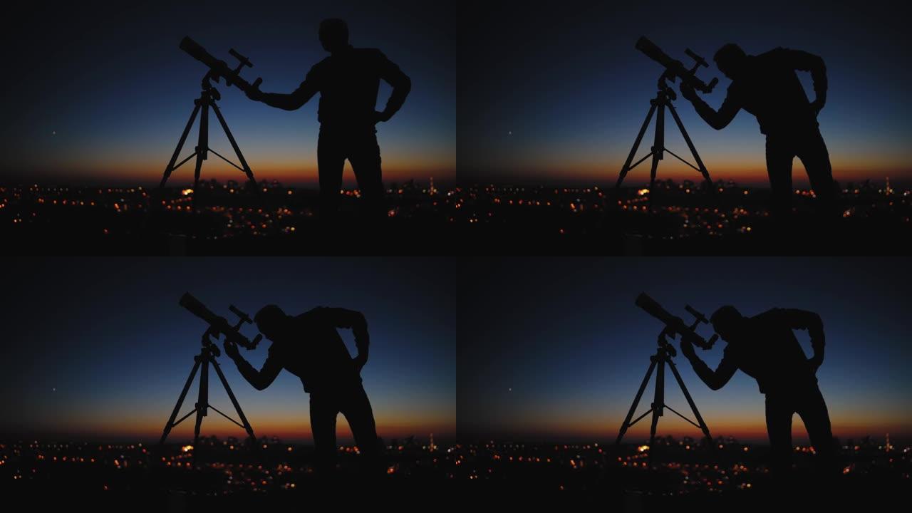 星空下的男人，望远镜和乡村的轮廓。