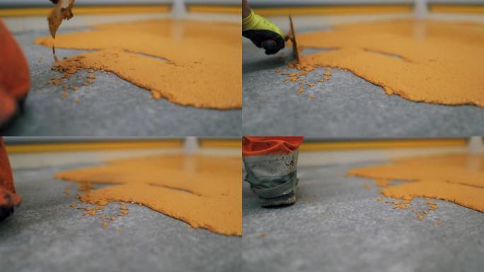 工人应用环氧树脂和聚氨酯地板系统。这些易于清洁的产品还具有防滑功能。