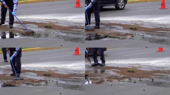 警察的特写镜头覆盖了意外堆积在街道上的汽油井