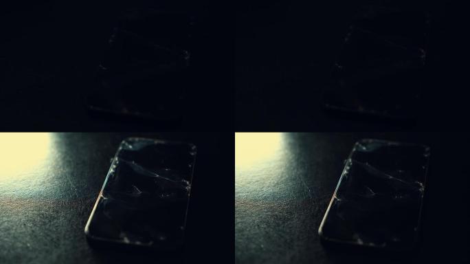 黑色纹理背景上的碎玻璃屏幕智能手机。闪烁的光。屏幕上的玻璃破裂。崩溃电话，断裂，修复，后悔概念。选择