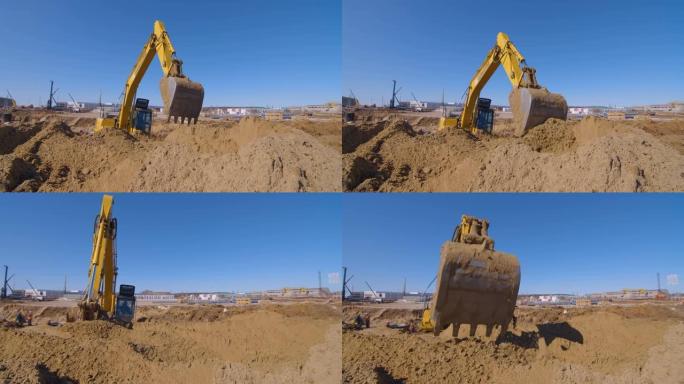 在建筑上的土方工程，挖掘机铲平了大片的沙子