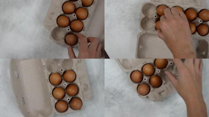 新鲜的自制农场鸡蛋在生态包装上的混凝土桌子上，交付和包装有机产品的概念。
