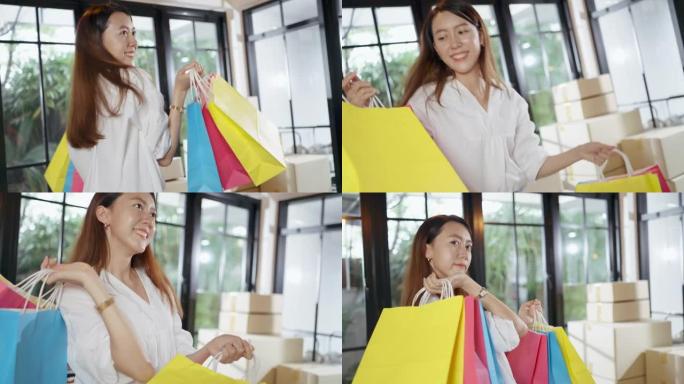 快乐的亚洲女人感觉无忧无虑地拿着购物袋跳进客厅