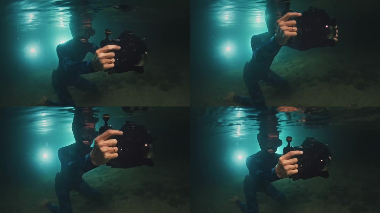 夜湖水下摄影师。穿着潜水衣的年轻女子带着水下相机潜水，晚上在湖里拍照
