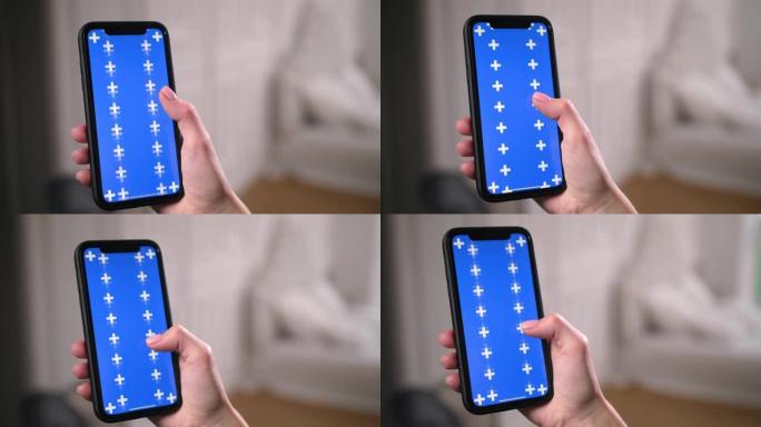 女人在智能手机应用程序中滑动，上下滚动蓝色色度键屏幕。