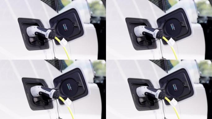 英国盖茨黑德 (Gateshead UK) 充电电动汽车的手持特写镜头 (EV，绿色可持续旅行)