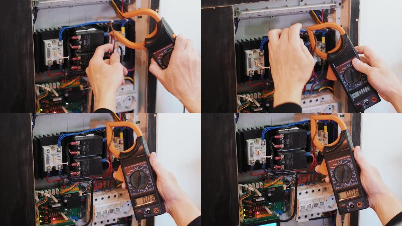 电工在控制面板中测试电流。电工工程师工作测试仪在机柜控制中测量电力线路的电压和电流。