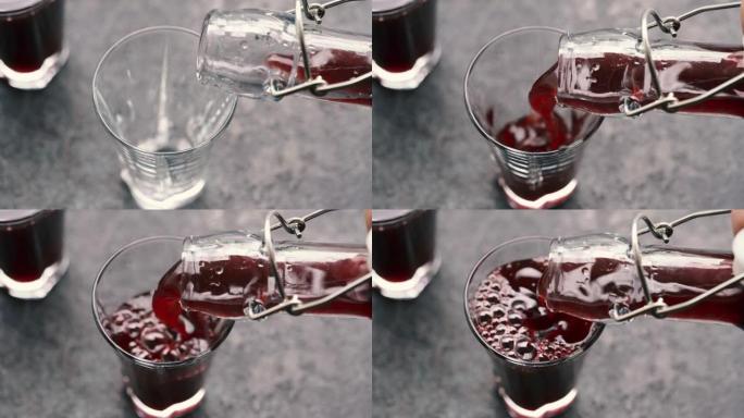将黑色的老糖浆从瓶子倒入玻璃杯中