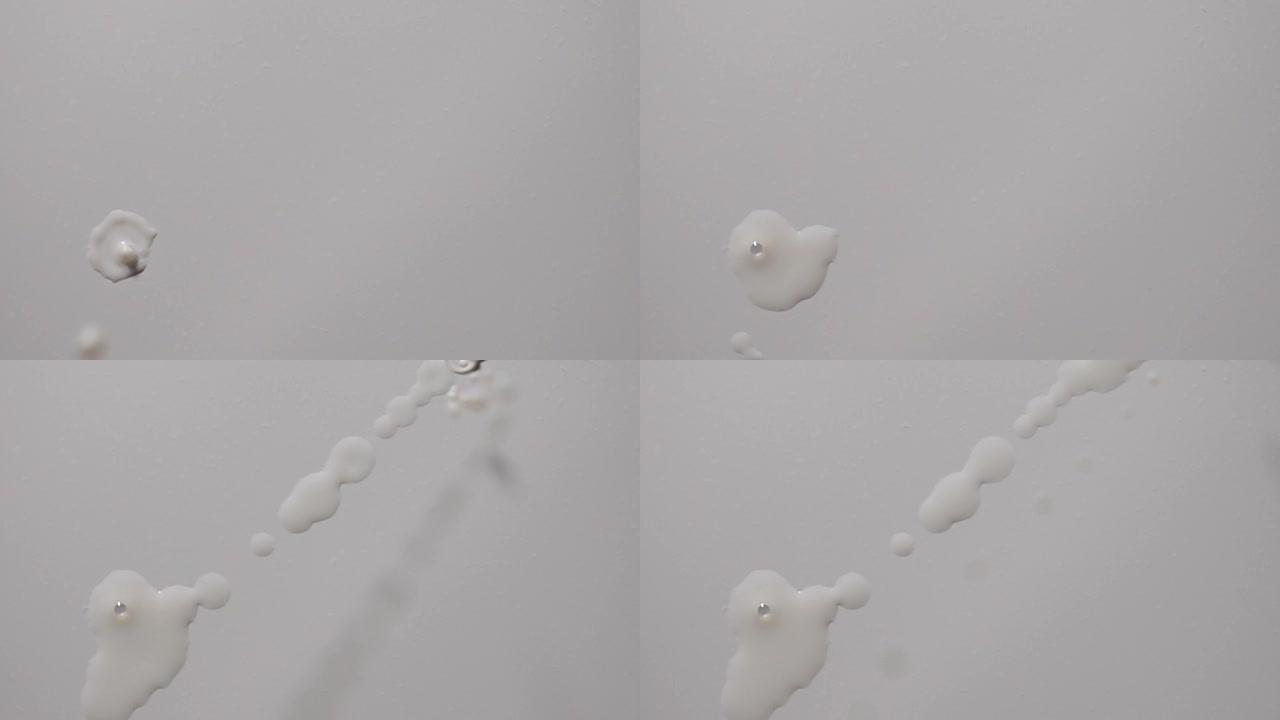 牛奶滴在白色背景在超慢动作1000 fps