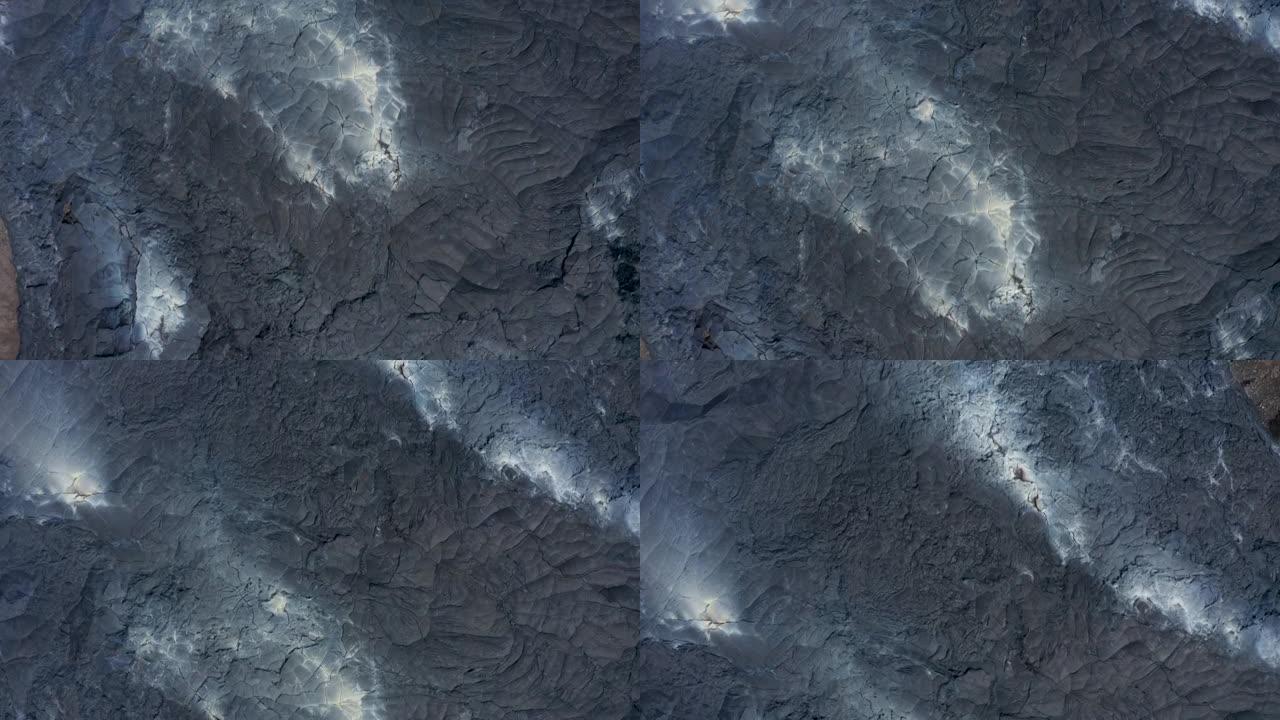 火山喷发后形成的新熔岩场中温暖凝固的熔岩层的空中鸟瞰俯视。法格拉达尔斯福杰尔火山。冰岛，2021
