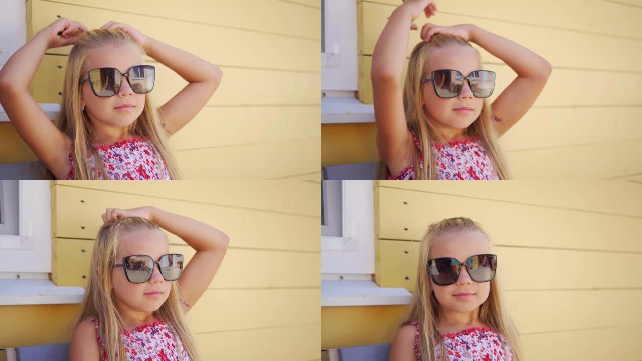 时尚的小女孩戴着大太阳眼镜，把头发拉直。时尚的休闲服装。年轻漂亮的白头发姑娘。