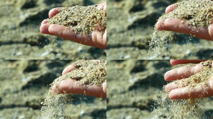 特写的沙子从女人的手中慢慢倒出来。