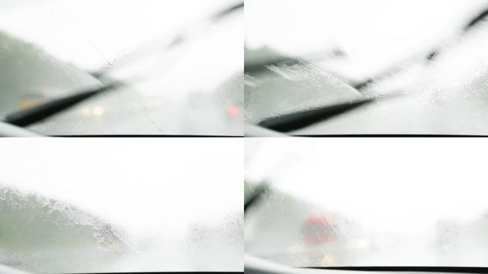 在能见度有限的条件下驾驶汽车: 大雨，刮水器清洁挡风玻璃。高速公路上有大灯的迎面而来的交通。恶劣天气