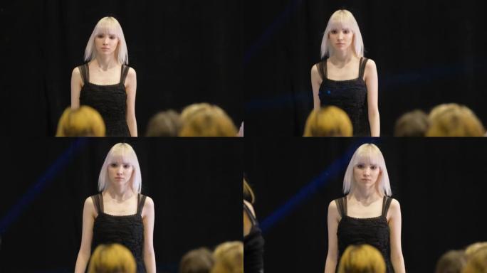 白色白化头发女孩在t台走秀讲台上移动。女模特玷污。