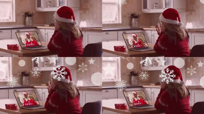 在与家人的笔记本电脑视频通话中，圣诞老人帽子上的女人在圣诞节雪花上的动画