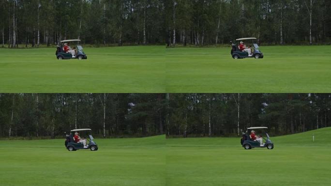 带两名男子和设备的高尔夫球车驶过高尔夫球场的侧视图