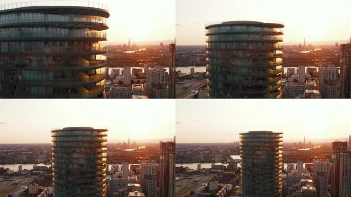 拉回背景中未来主义圆柱形公寓大楼竞技场塔和天际线的镜头。英国伦敦