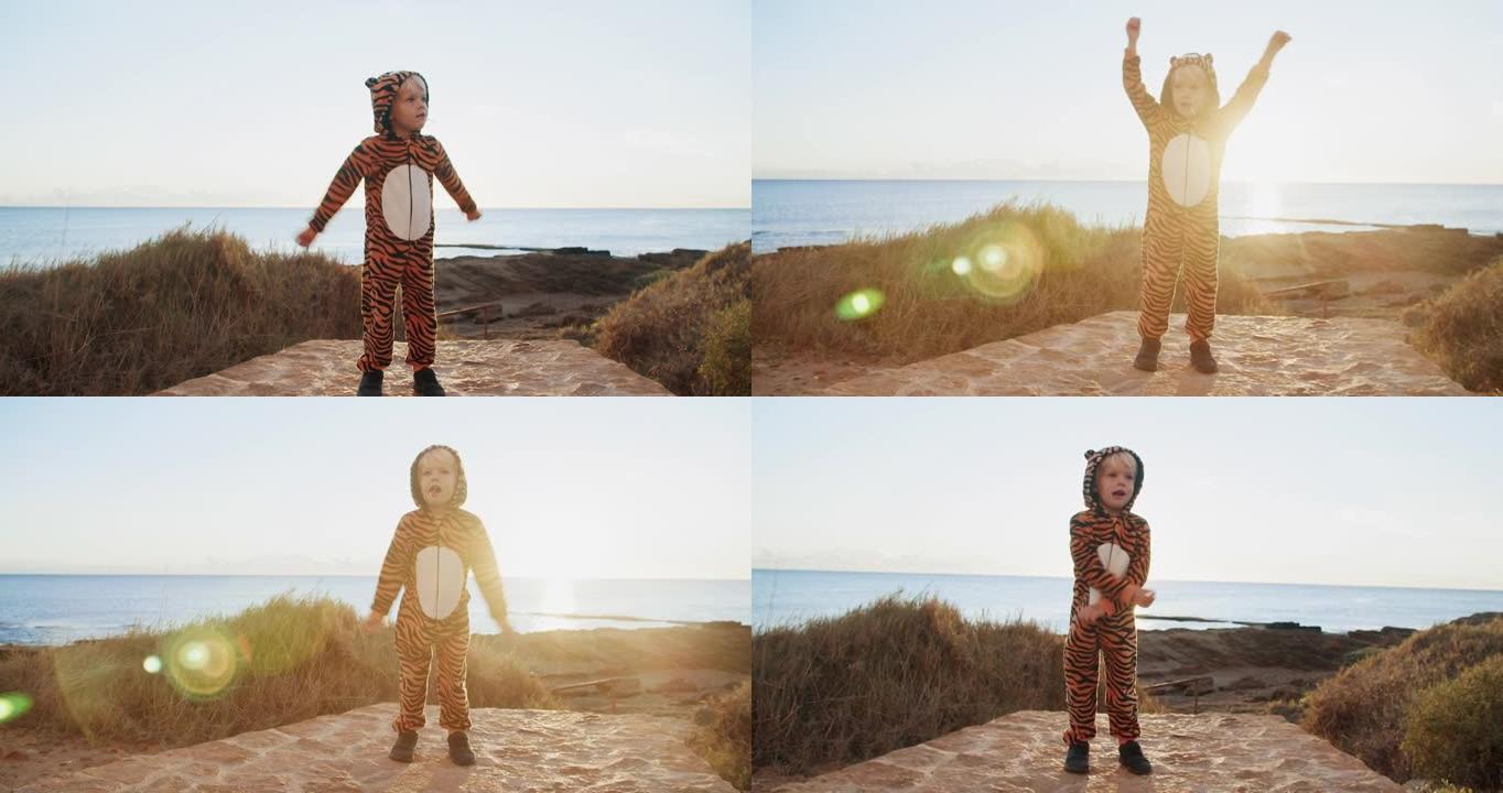 阳光明媚的黎明，穿着老虎服装的可爱的孩子在海边做运动锻炼