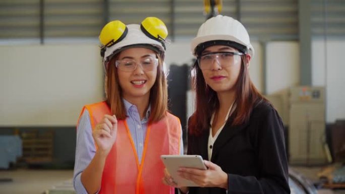 两名亚洲女工业工程师在车间检查工作的肖像
