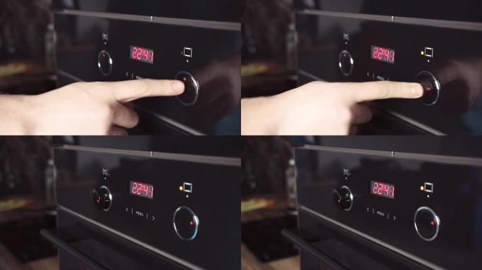 Man在烤箱面板上切换模式。男人的手转动旋钮打开烤箱