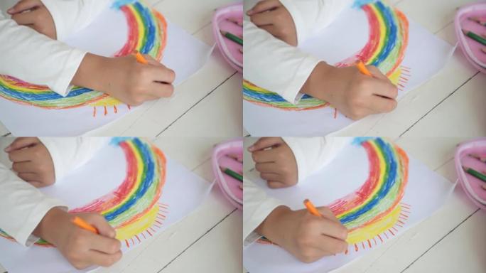 可爱的小女孩儿童艺术家画彩色彩虹画。在家中的创意艺术爱好。儿童发展和休闲概念。