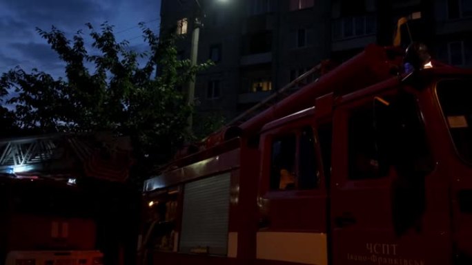 晚上在街上有消防车和闪光灯的火灾现场。