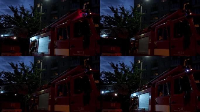 晚上在街上有消防车和闪光灯的火灾现场。