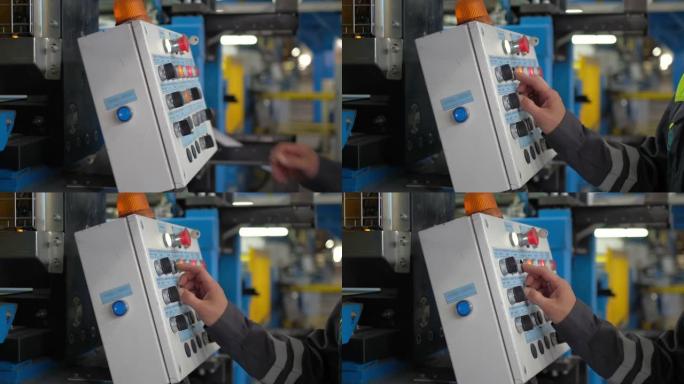 工厂工人正在编程，通过按下自动工业机器的按钮来检查冶金产品，设备，制造。现代金属工业的金属生产线