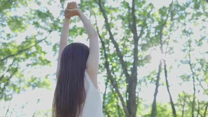 年轻的日本妇女在树林里放松