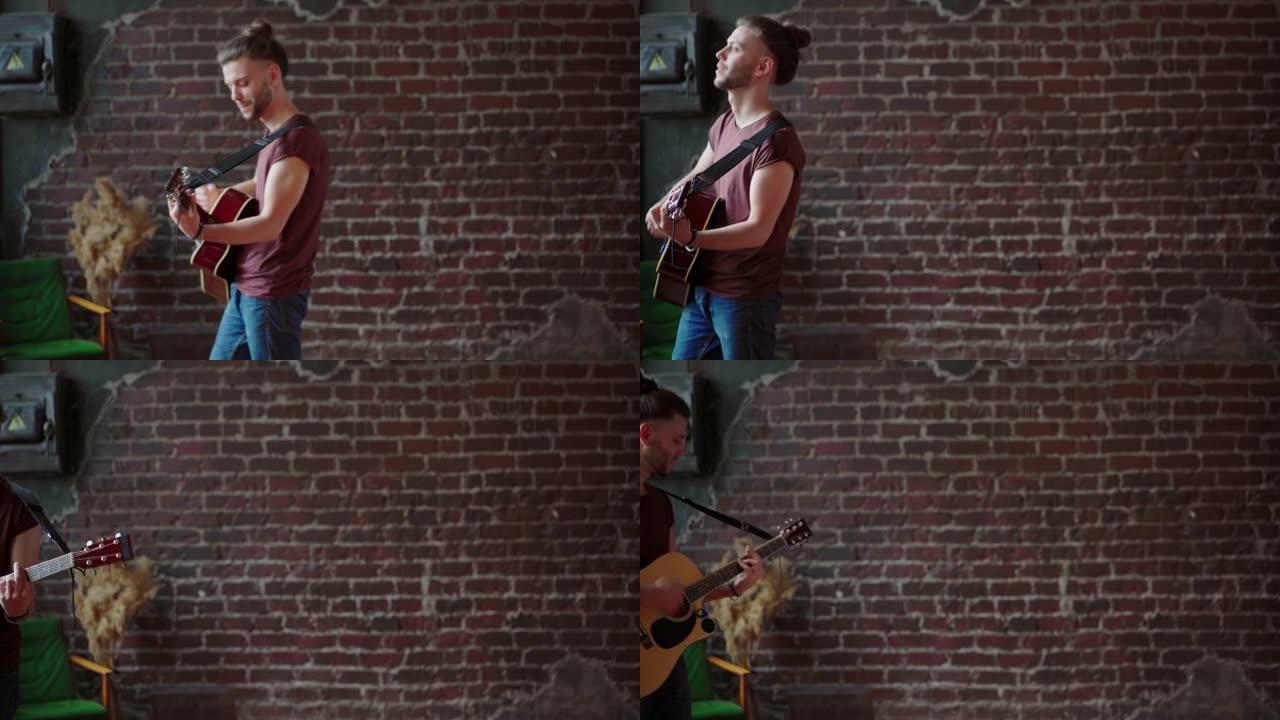 有原声吉他的男人来回行走砖墙背景创作音乐播放歌曲享受生活中等拍摄