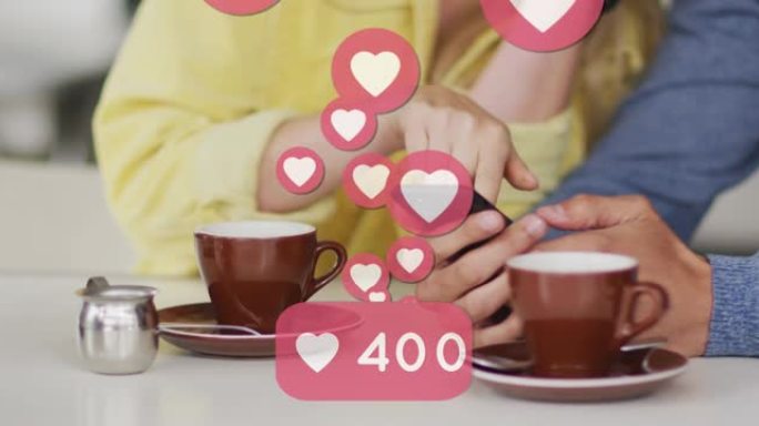 使用智能手机和喝咖啡的高加索夫妇漂浮的心脏图标动画