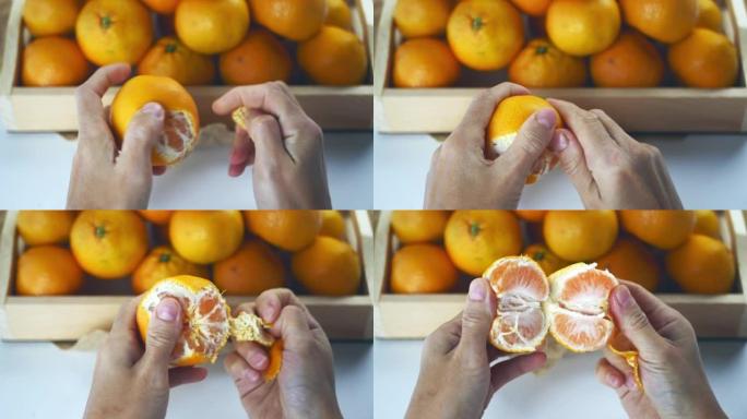 女性的手在盒子上剥橘子。在市场特写镜头的木箱中新鲜收获橘子
