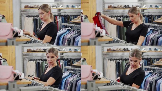 年轻女子在时尚商店挑选衣服。