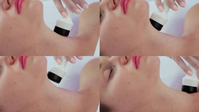 美容师借助美容院的液化石油气按摩抚平面部和颈部的皱纹。按摩去除面部和颈部的皱纹。