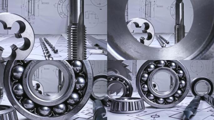 设计师办公桌上的机械零件。机械图、钻头和轴承。