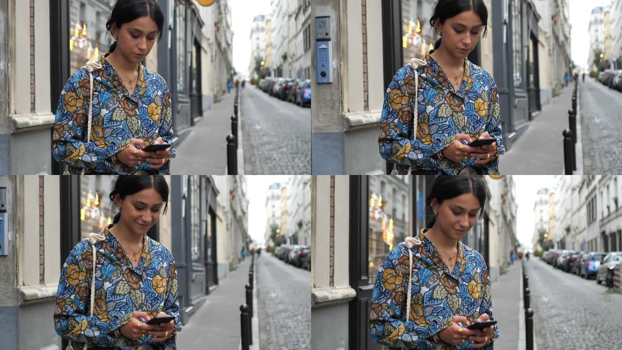 老城区美丽时尚的女人，使用智能手机 -- 巴黎蒙马特