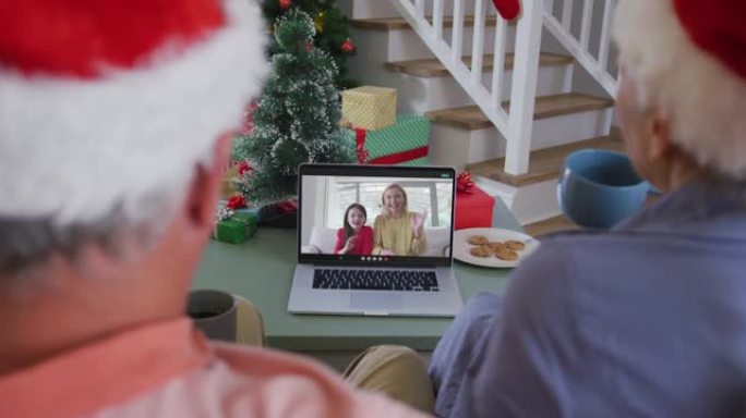 高级高加索夫妇在圣诞节与成年女儿和孙女进行视频通话