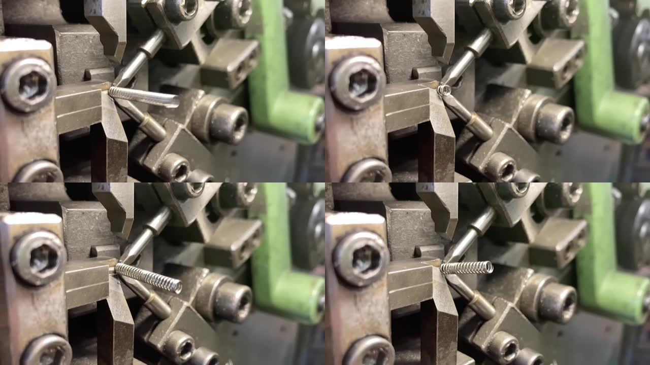 机器上的弹簧缠绕。生产中的弹簧制造。慢动作视频。