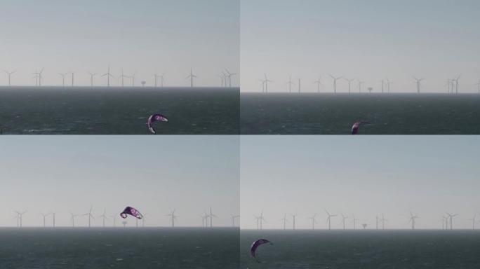 风筝冲浪前景，远眺海上炮舰沙地海上风电场。埃塞克斯海岸