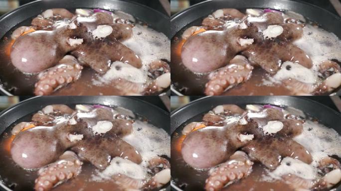 餐厅厨房里煮海鲜。美味的大章鱼在煎锅里煮沸。在锅里煮沸的水。章鱼准备好了。食物视频。4 k视频